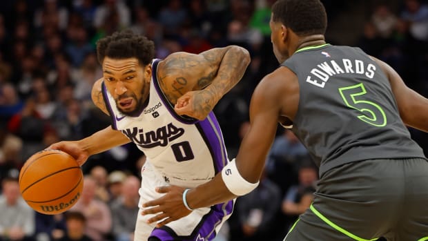 Mar 1, 2024; Minneapolis, Minnesota, USA; Sacramento Kings guard Malik Monk (0) works around Minnesota Timberwolves guard Anthony Edwards (5) in the first quarter at Target Center. Mandatory Credit: Bruce Kluckhohn-USA TODAY Sports  